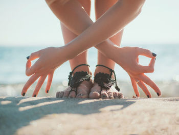 Low section of women standing on beach