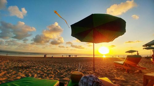 Scenic view of beach against sky during sunset