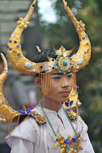 Close-up of young man wearing headdress during traditional festival