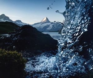 Scenic view of waterfall against sky