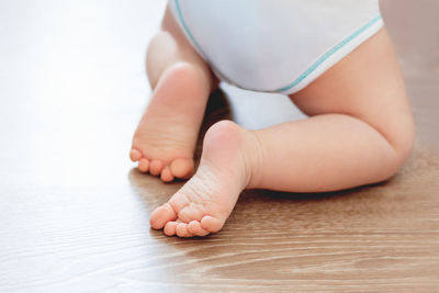 Low section of baby feet on hand