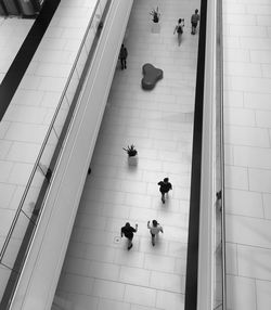 High angle view of people walking on floor in shopping mall