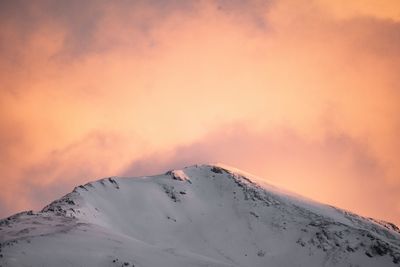 Snow covered mountain against sky during sunset