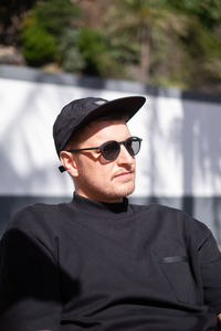 Man wearing sunglasses standing outdoors