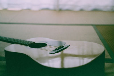 Close-up of guitar on table