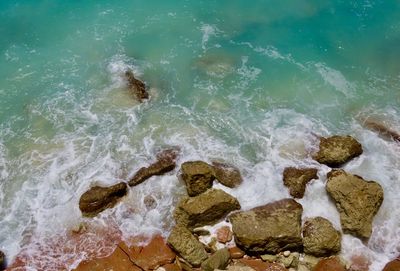 High angle view of rocks in sea