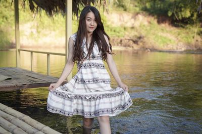 Young woman standing in water