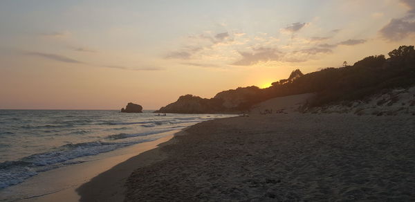 Scenic view of beach against sky during sunset