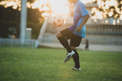 Full length of man playing soccer on field