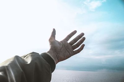 Midsection of person against sea against sky