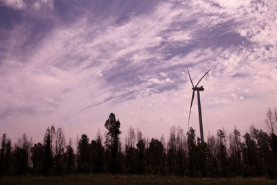 Scenic view of field against sky during sunset with a wind mill