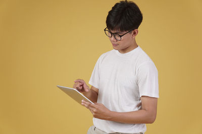 Full length of man using mobile phone