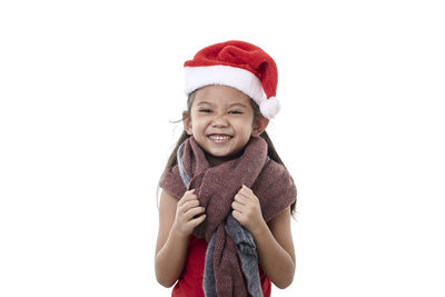Portrait of smiling girl wearing hat against white background