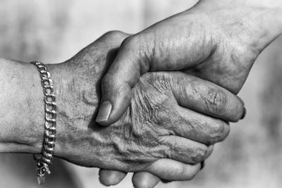 Cropped image of people shaking hands outdoors