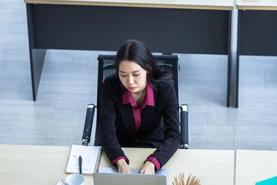 Young woman sitting on table