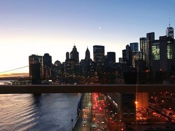 Illuminated buildings in city against sky