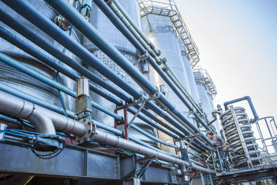 Worker controlling stainless steel tanks for food industry