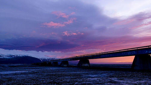 Purple sunset beyond a bridge in iceland