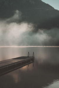 Pier over lake against sky