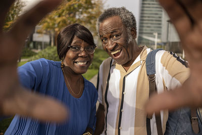 Cheerful senior couple gesturing at park