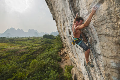 Man standing on rock against mountains