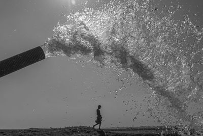 Man standing on beach against sky