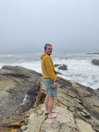 Portrait of young man standing on a cliff at spooners cove in montana de oro