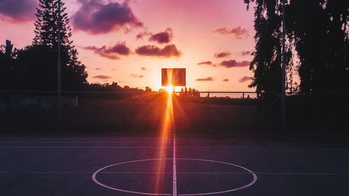 Silhouette basketball hoop against sky during sunset
