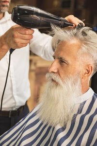 Side view of man using mobile phone