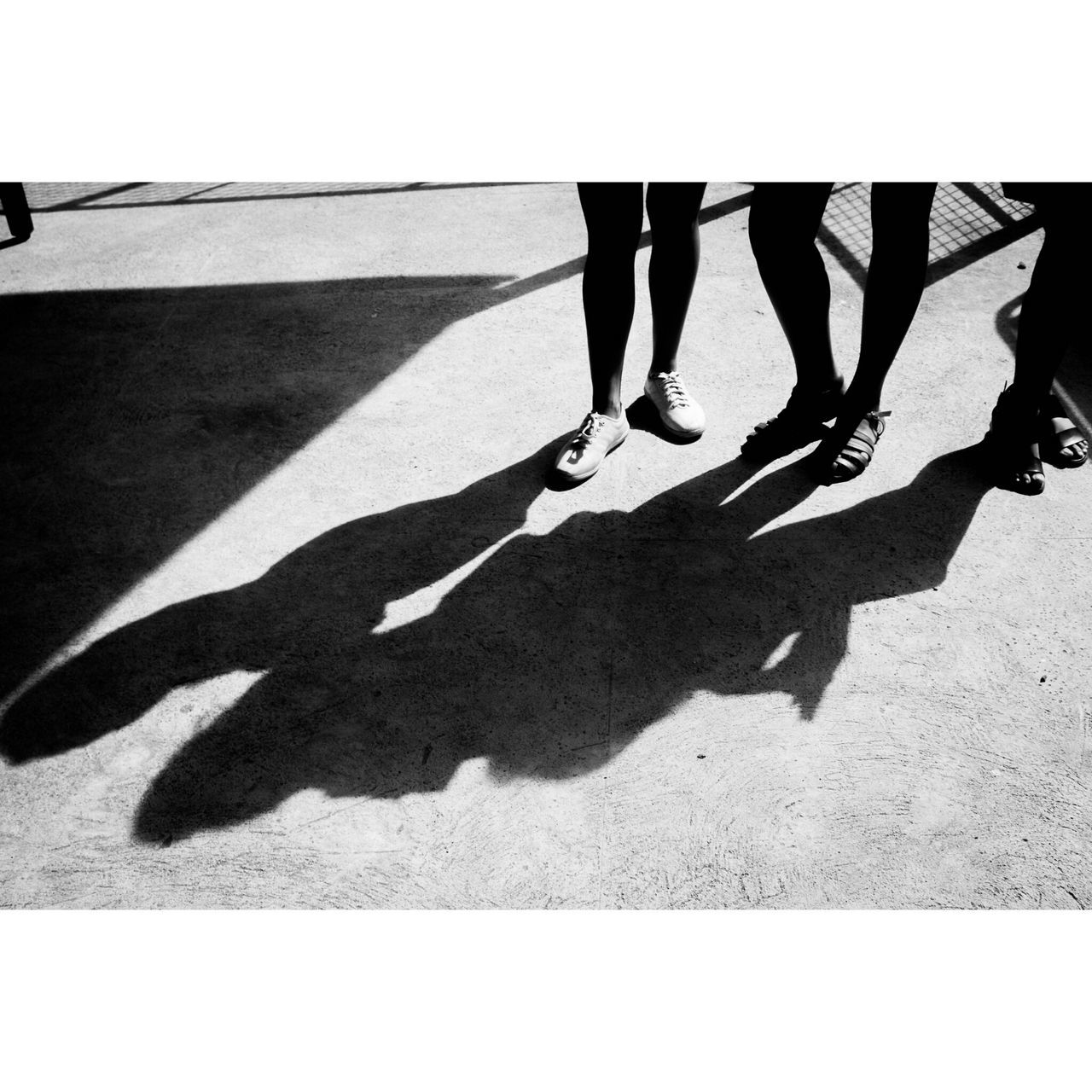 shadow, low section, real people, sunlight, women, lifestyles, two people, day, men, human leg, human body part, leisure activity, outdoors, standing, togetherness, adults only, adult, people