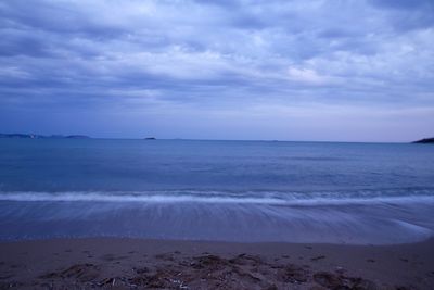 Scenic view of sea against cloudy sky