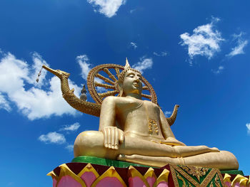 Low angle view of statue against blue sky