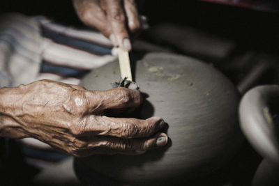 Cropped hands making pottery in workshop