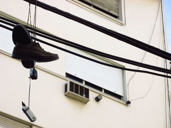 Low angle view of electric lamp hanging on ceiling in building