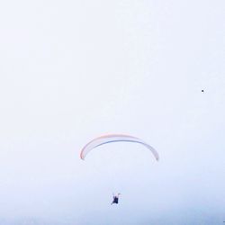 Distant view of people paragliding