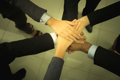 High angle view of people hands on tiled floor