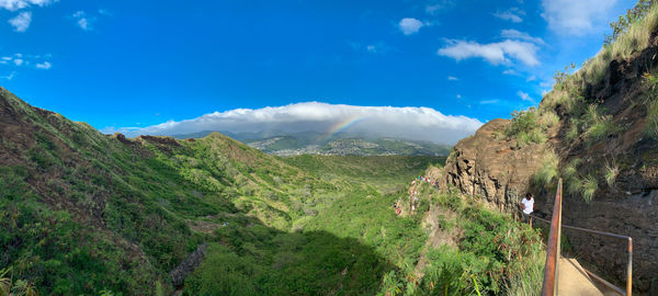 Scenic view of mountains against blue sky