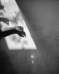 Shadow of woman hand on wall