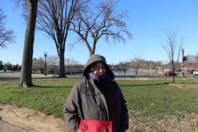 Woman in warm clothing standing on land