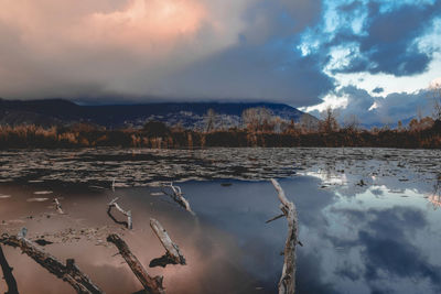 Scenic view of lake against sky during winter