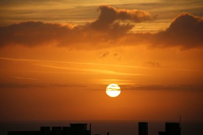 Scenic view of sea against romantic sky at sunset