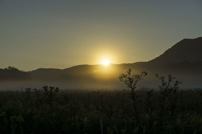 Scenic view of silhouette mountains against sky during sunset