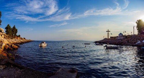 Sailboat on sea shore against sky