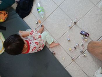 High angle view of girl playing on floor