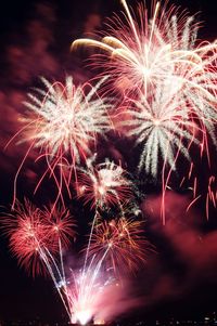 Low angle view of firework display at night