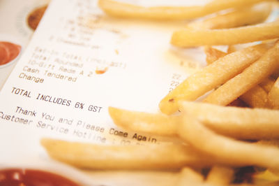 Close-up of bill and french fries