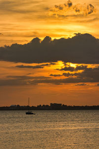 Scenic view of sea against orange sky