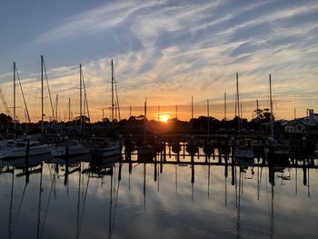 Sailboats in marina at sunset