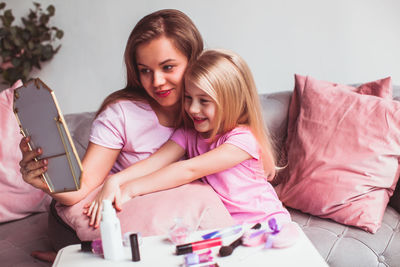 Portrait of happy girl and woman at home