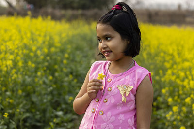 Close-up of girl standing on field